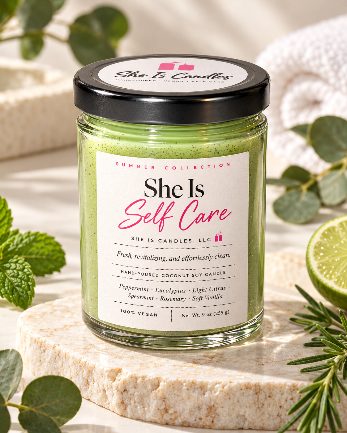 She Is Self Care hand-poured vegan coconut soy candle by She Is Candles surrounded by eucalyptus, mint, and lime