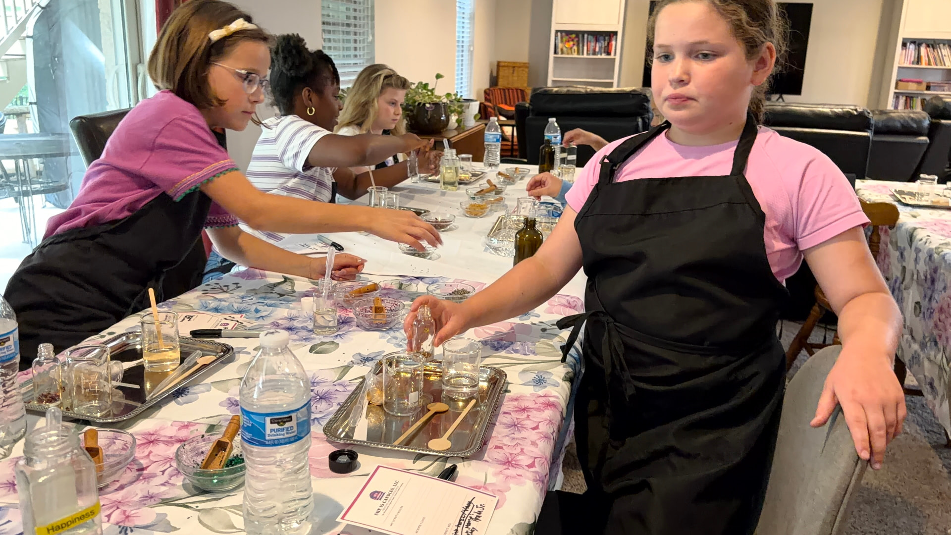 Kids blending their own perfumes at a birthday fragrance table