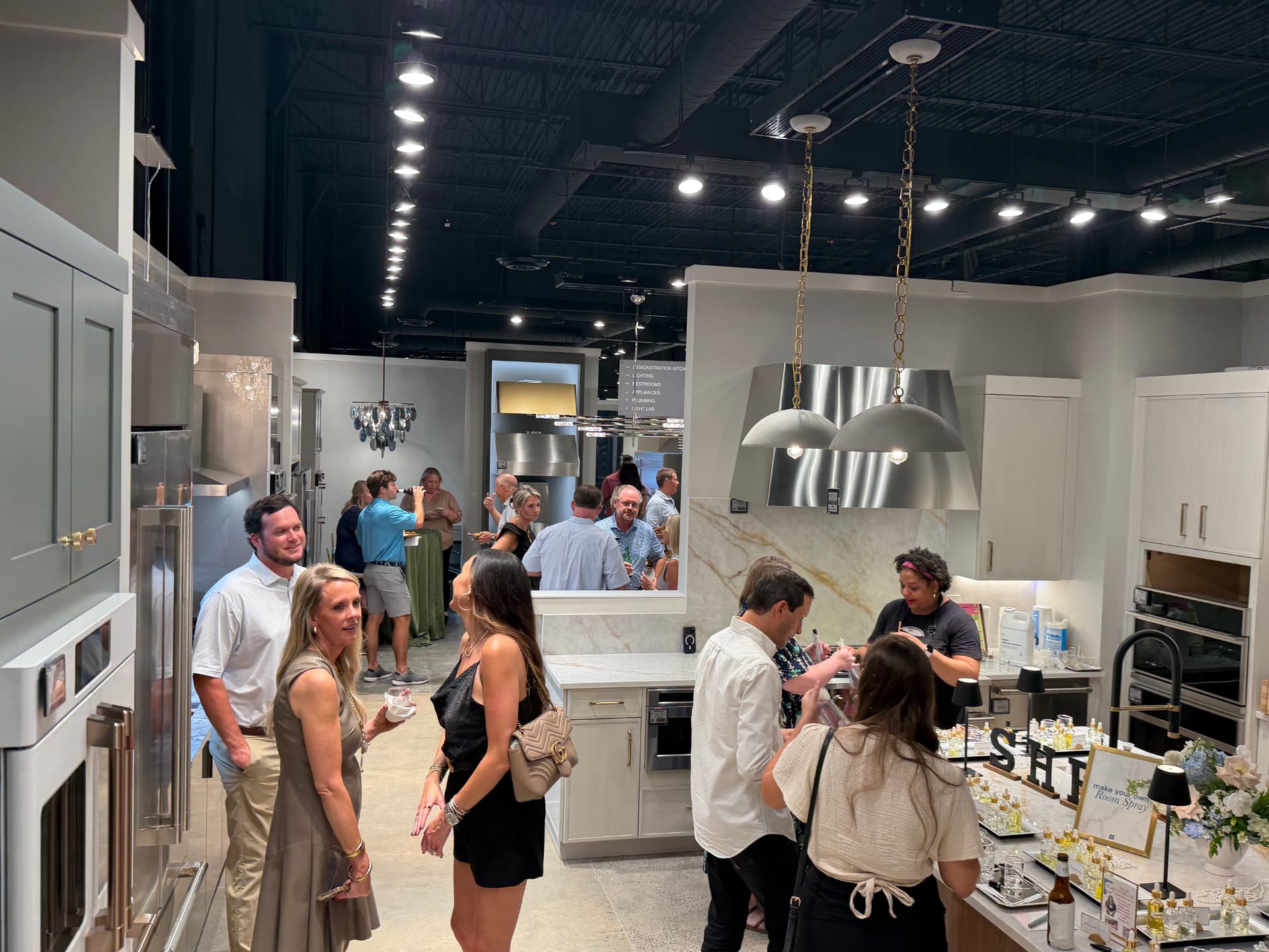 Guests mingling around the fragrance bar during a corporate event at Ferguson Home